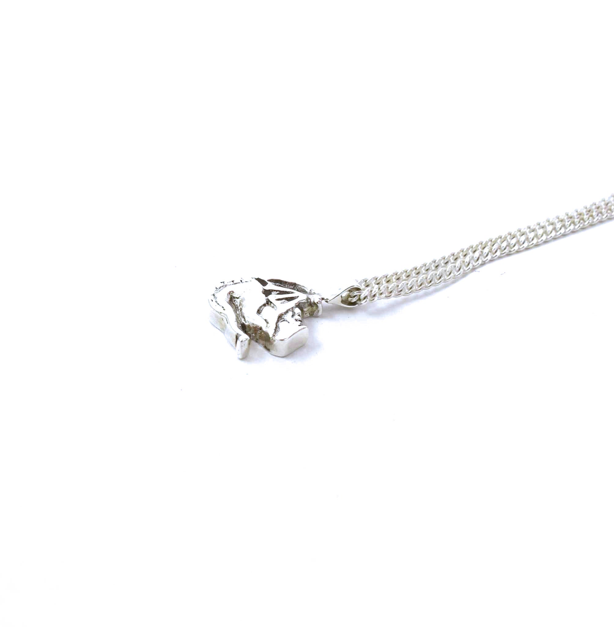 Right side view of sterling silver sleeping dragon pendant