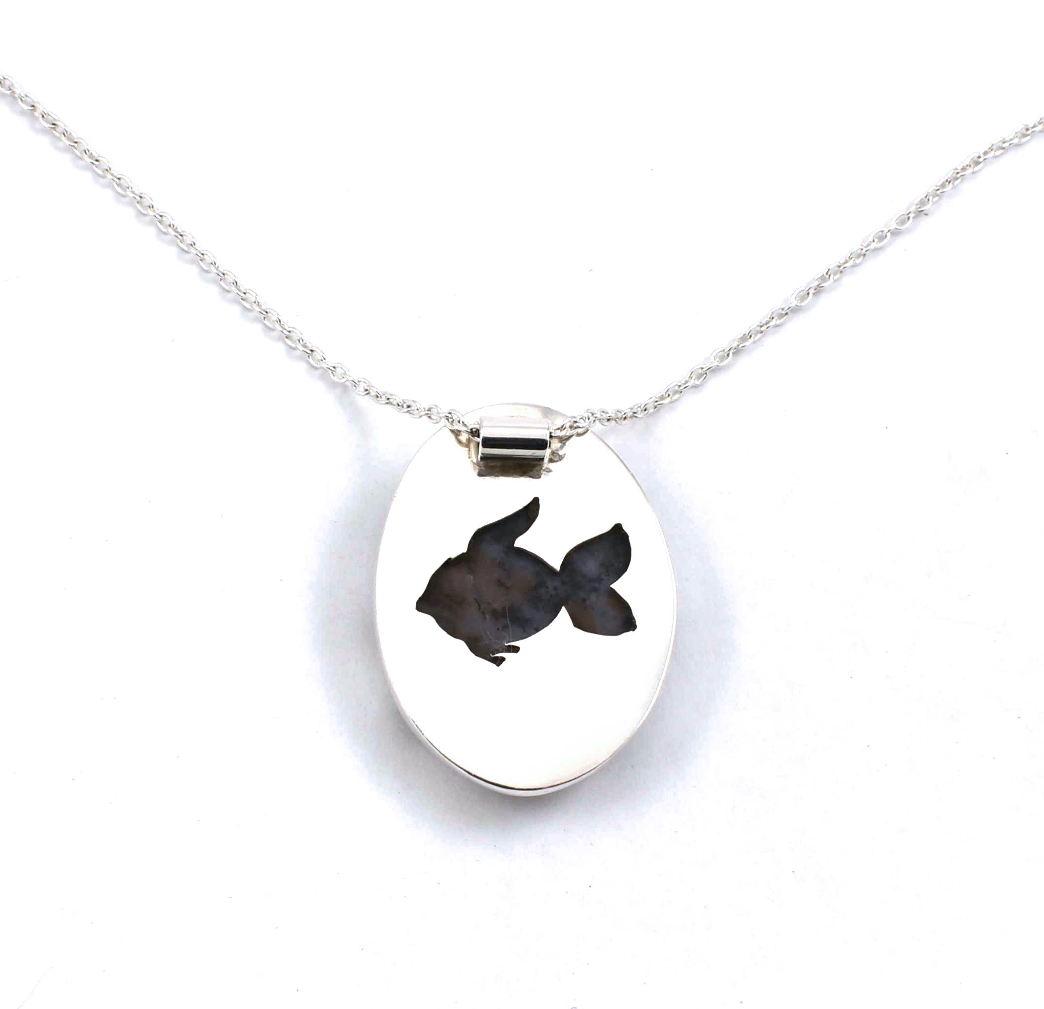Rear view of sterling silver agate pendant with seahorse and fish accents