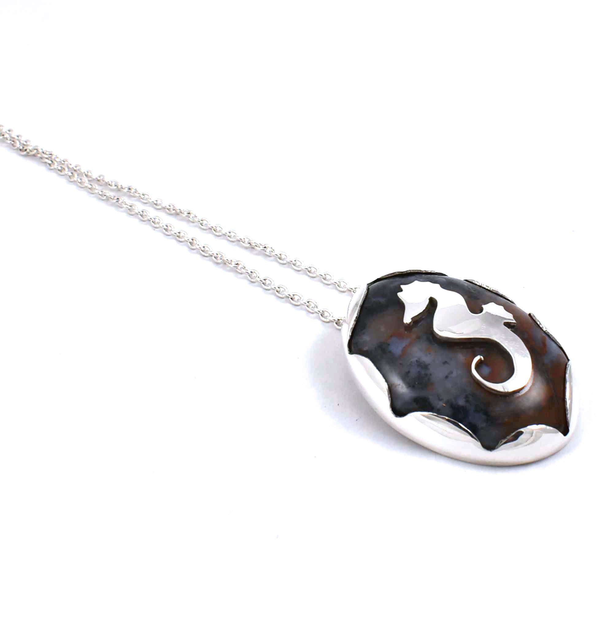 Left side view of sterling silver agate pendant with seahorse and fish accents