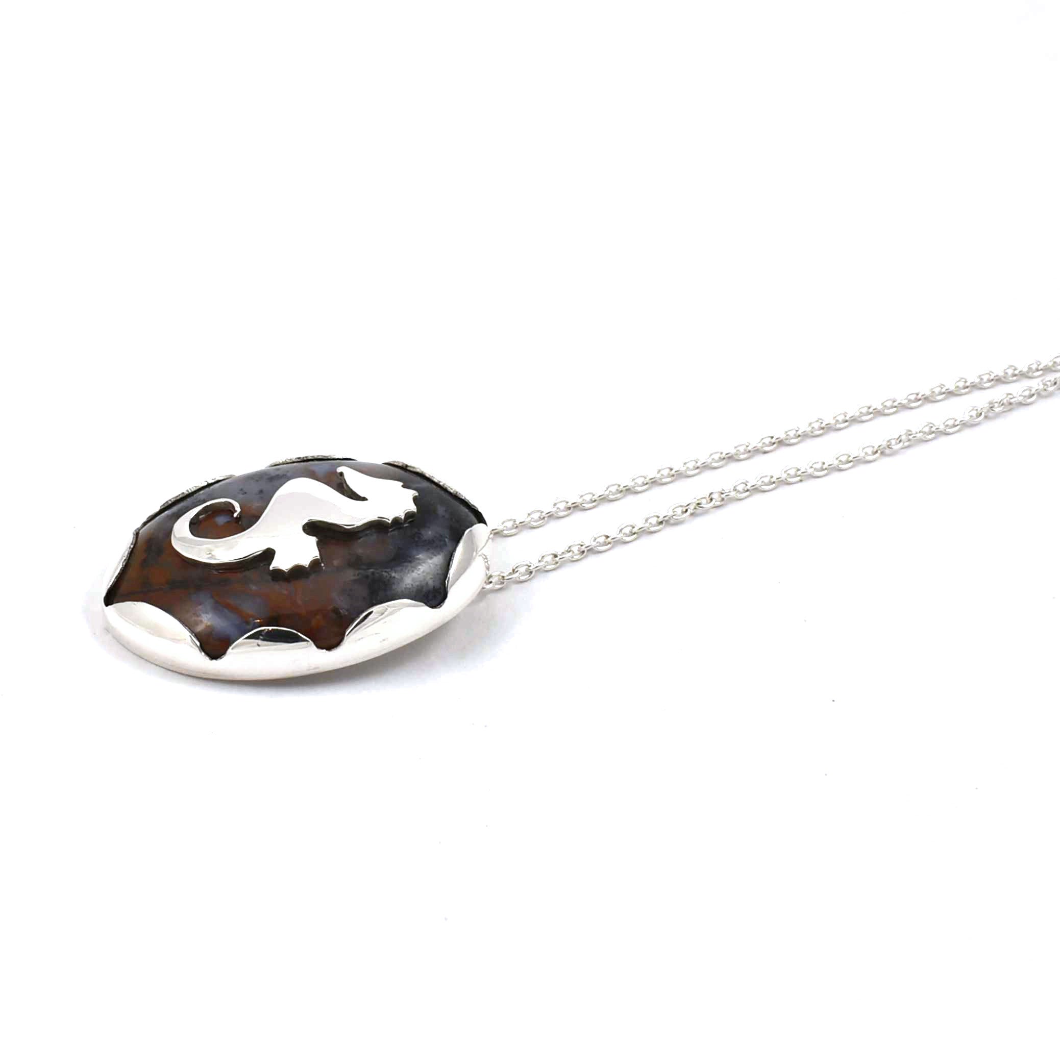 Right side view of sterling silver agate pendant with seahorse and fish accents