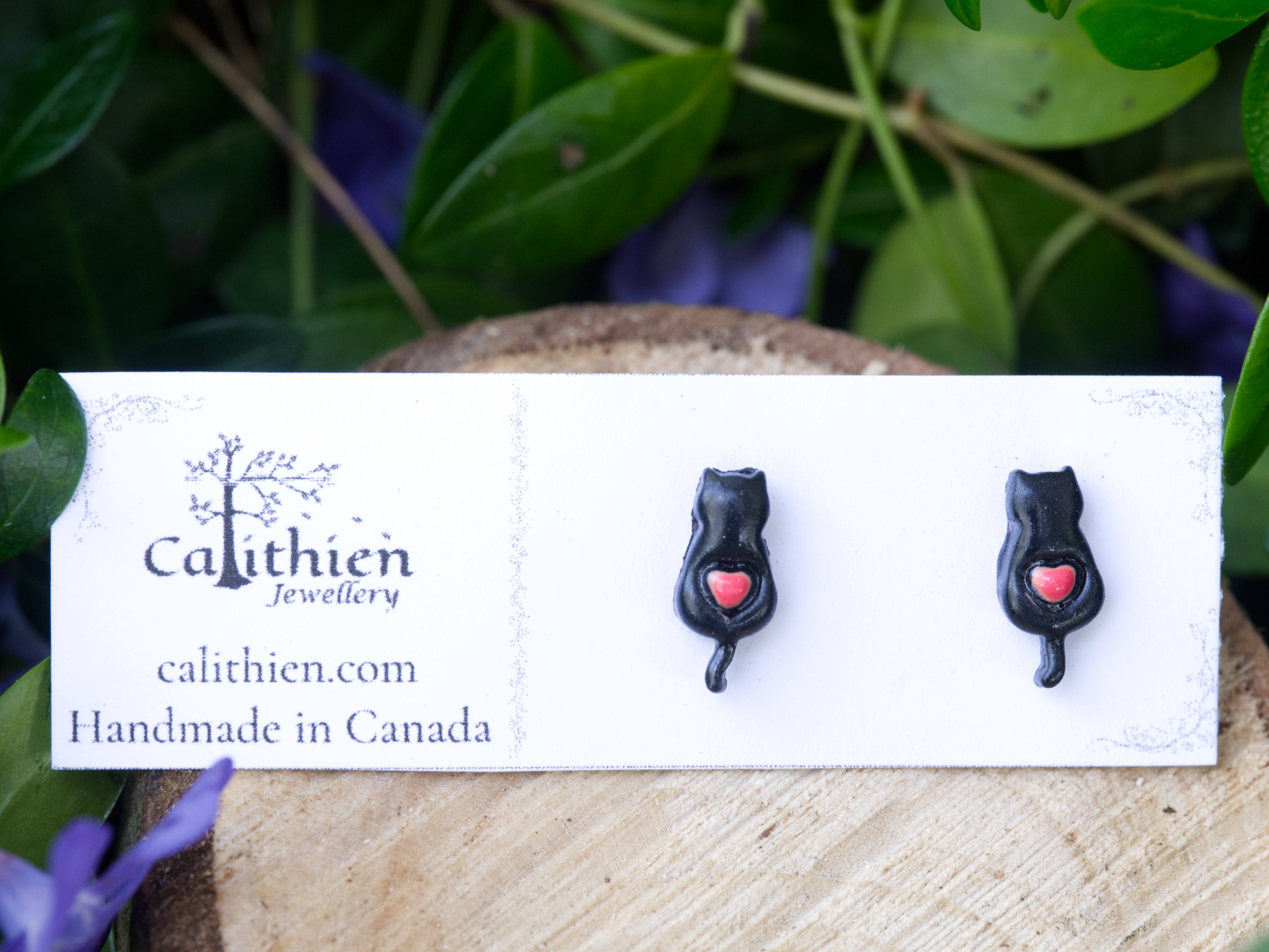 Black cat stud earrings mounted on Calithien Jewellery branded display card reading Handmade in Canada