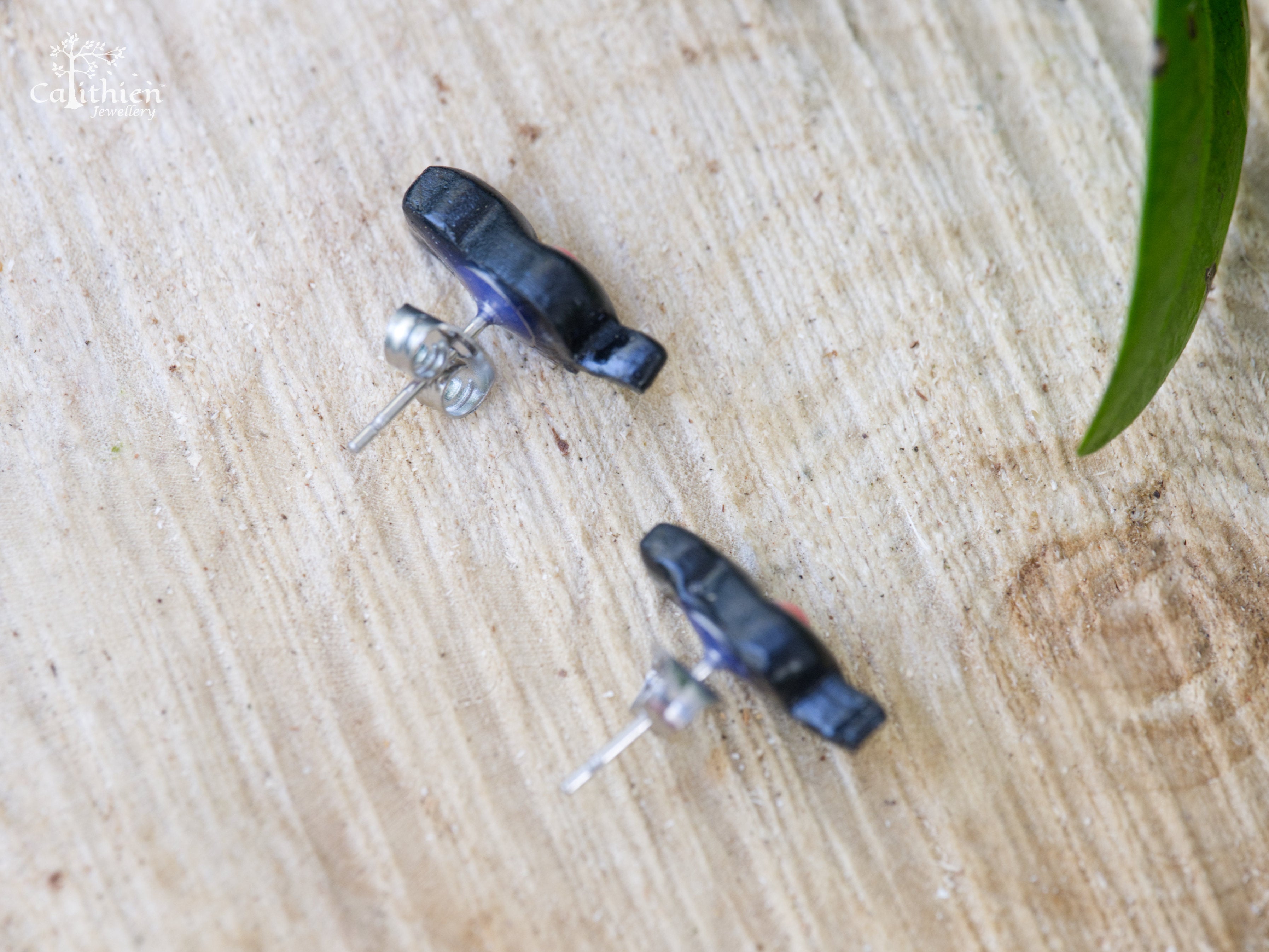  Macro view of 316 grade surgical steel earring post and butterfly back on black polymer clay cat stud
