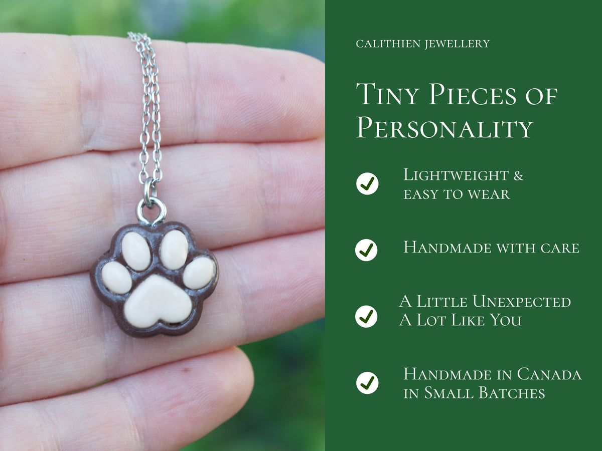 Product information graphic highlighting features of the handmade brown paw print necklace and its stainless steel components