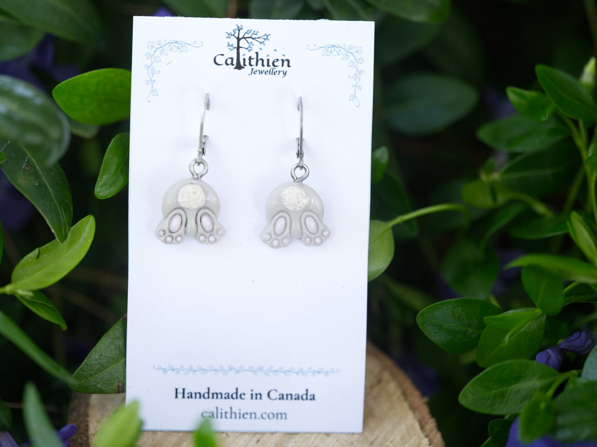 Handmade bunny dangle earrings shown on a branded card with a floral backdrop