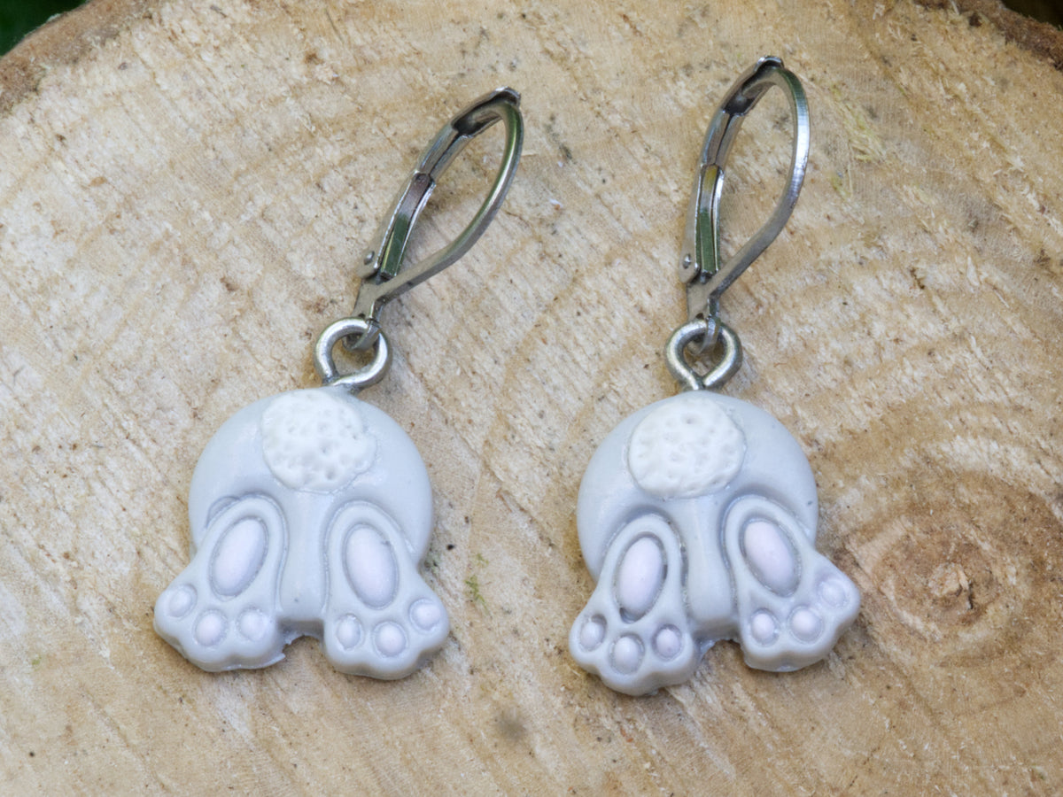 Grey bunny bum dangle earrings with pink paw pads and white tails on surgical steel leverback closures