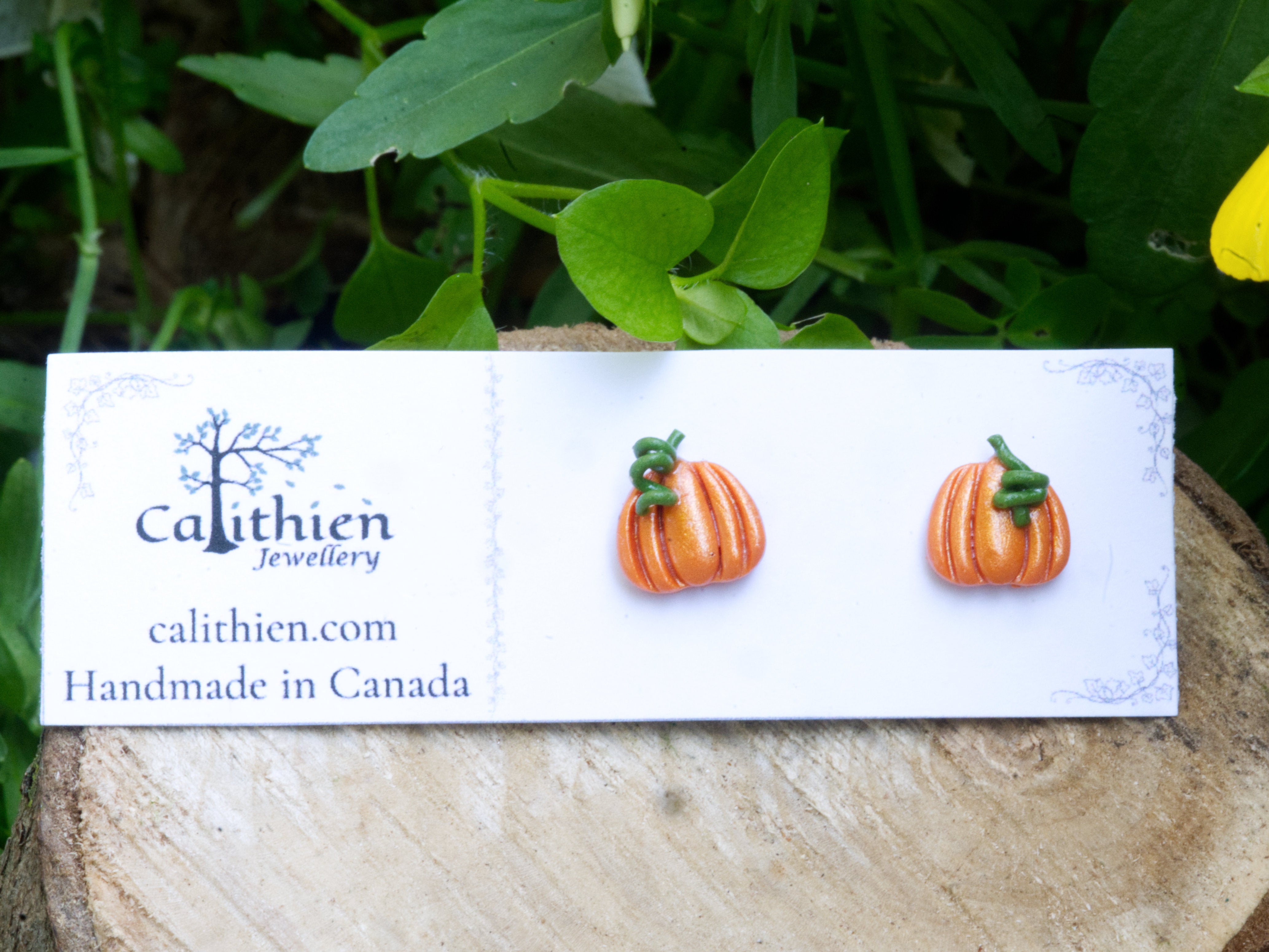 Pumpkin stud earrings on Calithien Jewellery branded display card reading Handmade in Canada