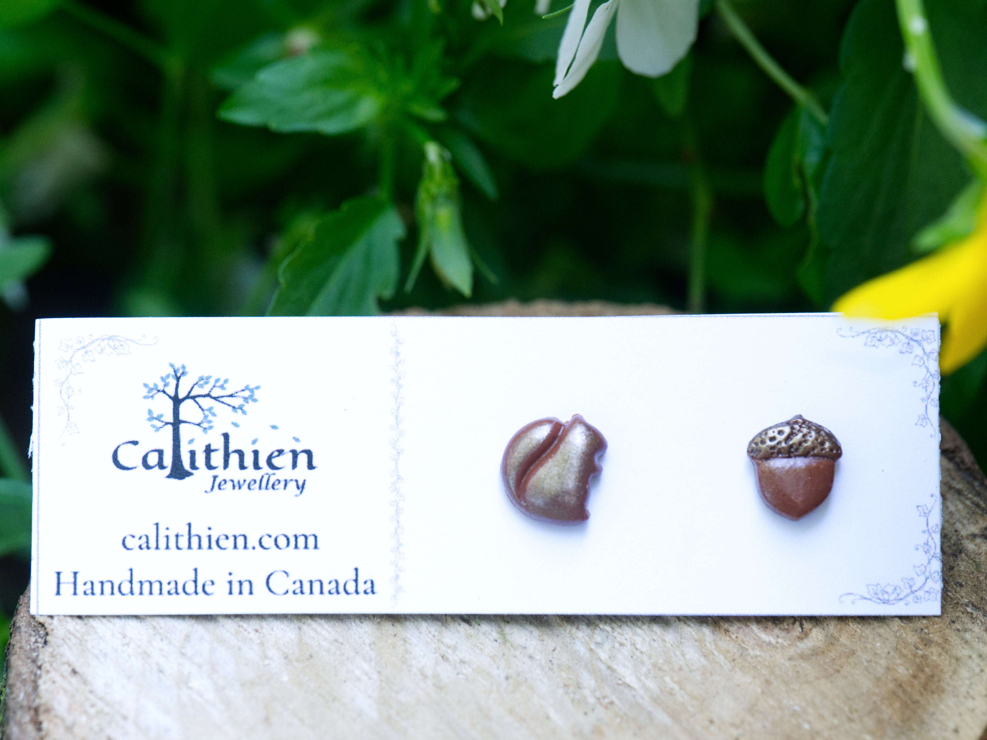 Mismatched squirrel and acorn stud earrings on Calithien Jewellery branded display card reading Handmade in Canada