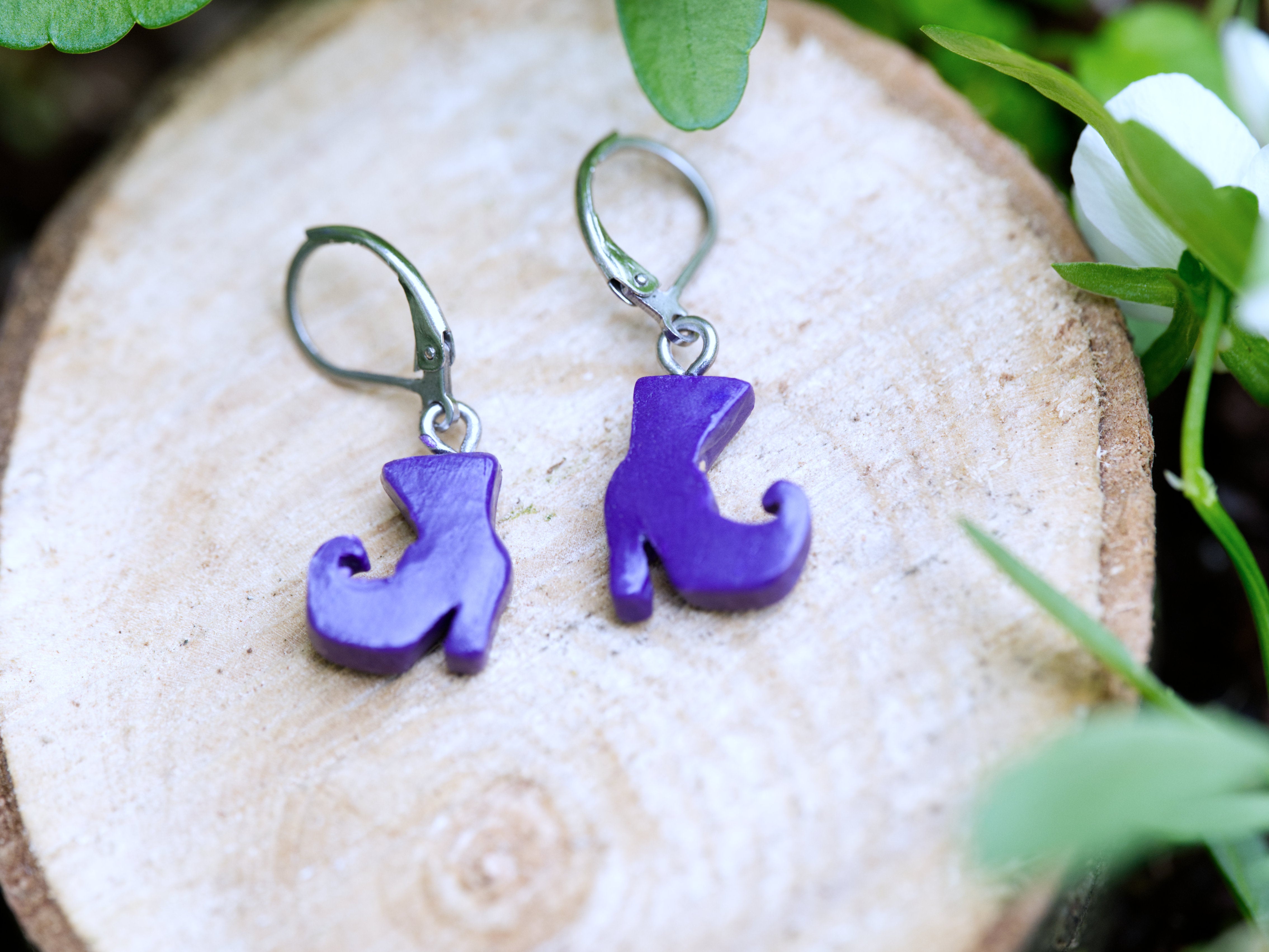 Reverse view of purple polymer clay witch boot earring showing satin finish and leverback hook attachment