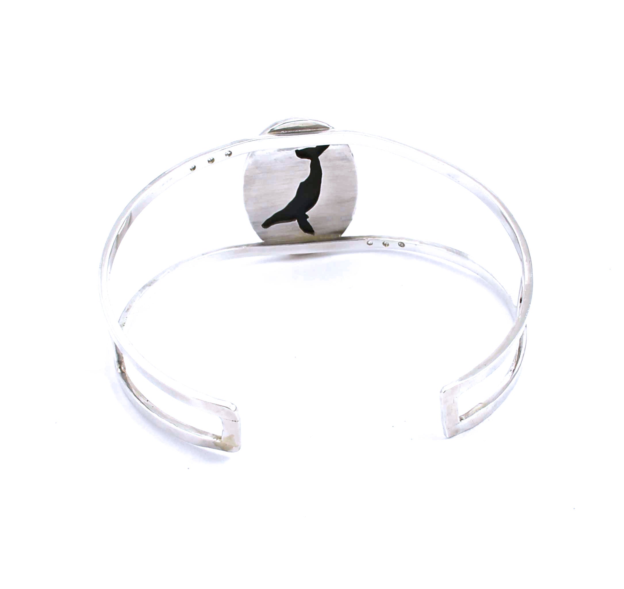 Rear view of sterling silver cuff bracelet with hawk's eye and white sapphires
