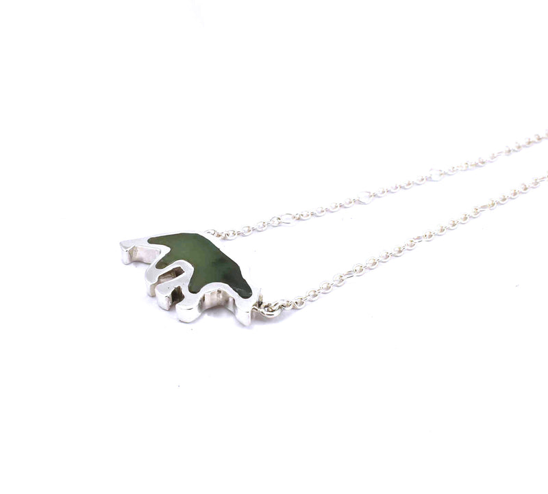 Right side view of sterling silver bear pendant with jade gemstone inlay