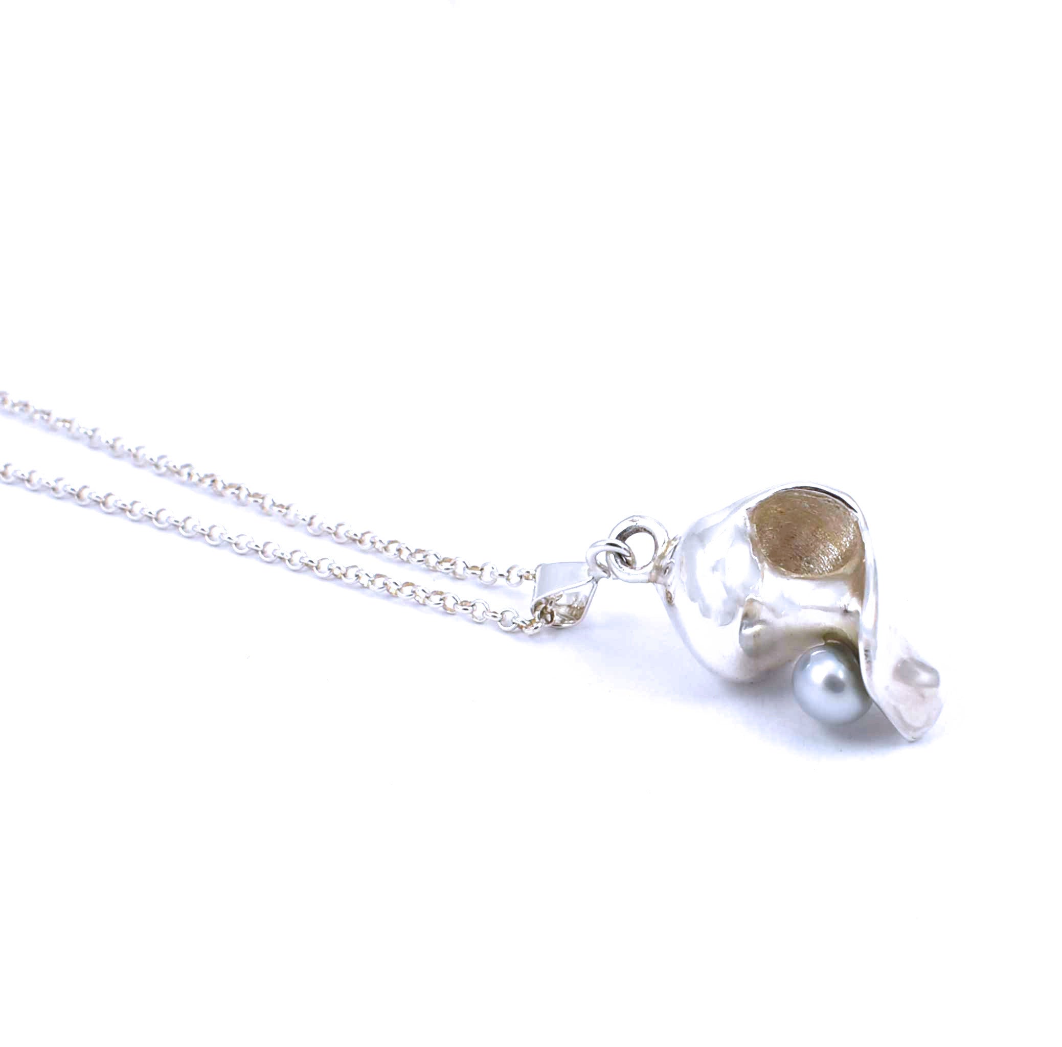 Left side view of large sterling silver periwinkle shell pendant with a blue freshwater pearl