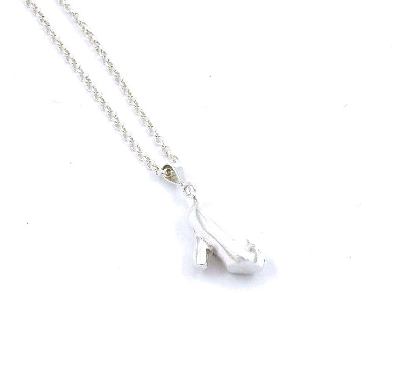 Left side view of sterling silver cinderella's slipper pendant with blue sapphire