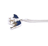 Right side view of medium sterling silver bear pendant with tree accent and crushed gemstone inlay